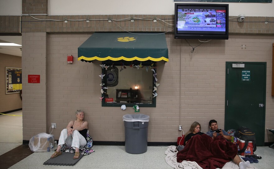 Evacuees wait for the arrival of 2018's Hurricane Florence inside a North Carolina school shelter. Many coastal states have long-standing shelter shortages. That's being exacerbated this year by recommendations from the American Red Cross and the Centers for Disease Control and Prevention to give evacuees up to three times more personal space to allow for social distancing.