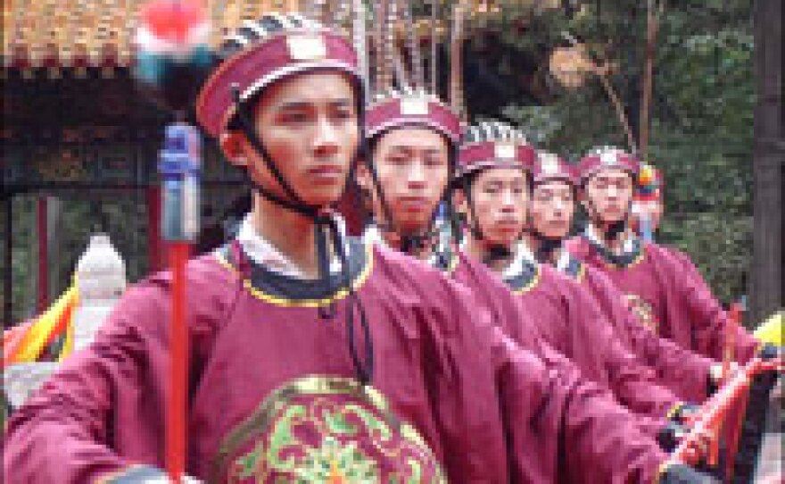 Attendants hold ritual implements at a celebration marking Confucius' 2,558th birthday at his birthplace in Qufu, Shandong province, on Sept. 28. These days, Confucius has become a sort of Chinese brand.