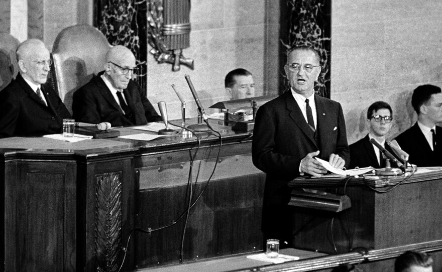 President Johnson charts a course for his administration in a speech to Congress on Nov. 27, 1963. Seated behind the new president are House Speaker John McCormack (left) and Sen. Carl Hayden.