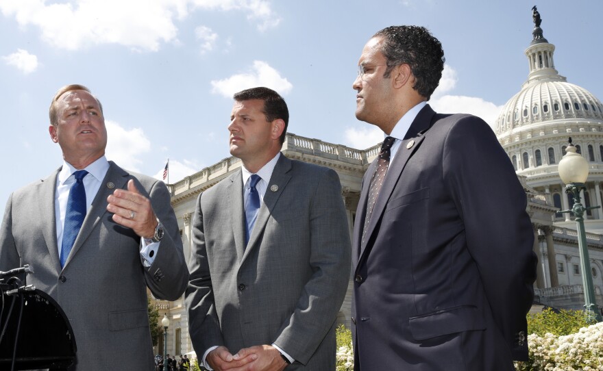 Rep. Jeff Denham, R-Calif., (left) speaks next to Rep. David Valadao, R-Calif., and Rep. Will Hurd, R-Texas, during a May 9 news conference on a discharge petition to force votes on immigration legislation.
