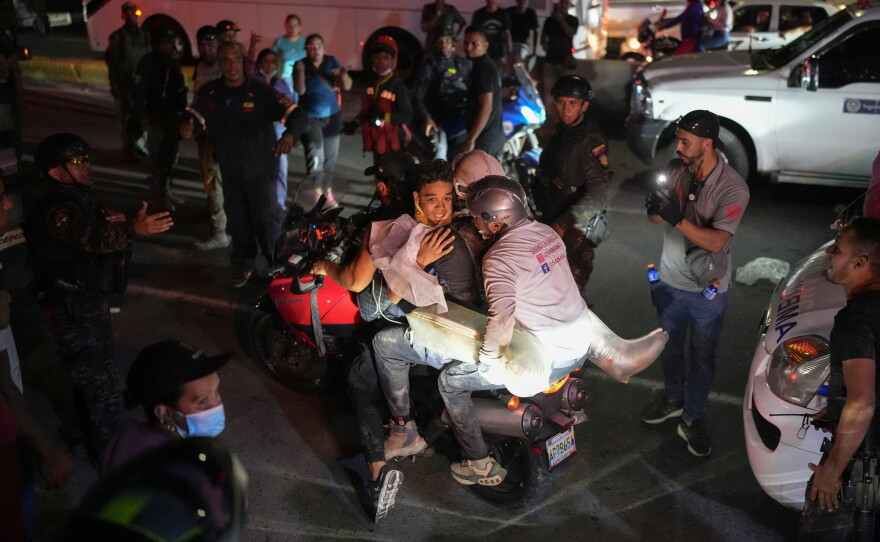 A youth rescued from the debris is taken away on a motorcycle two days after earthquakes struck La Guaira, Venezuela, Friday, June 26, 2026.