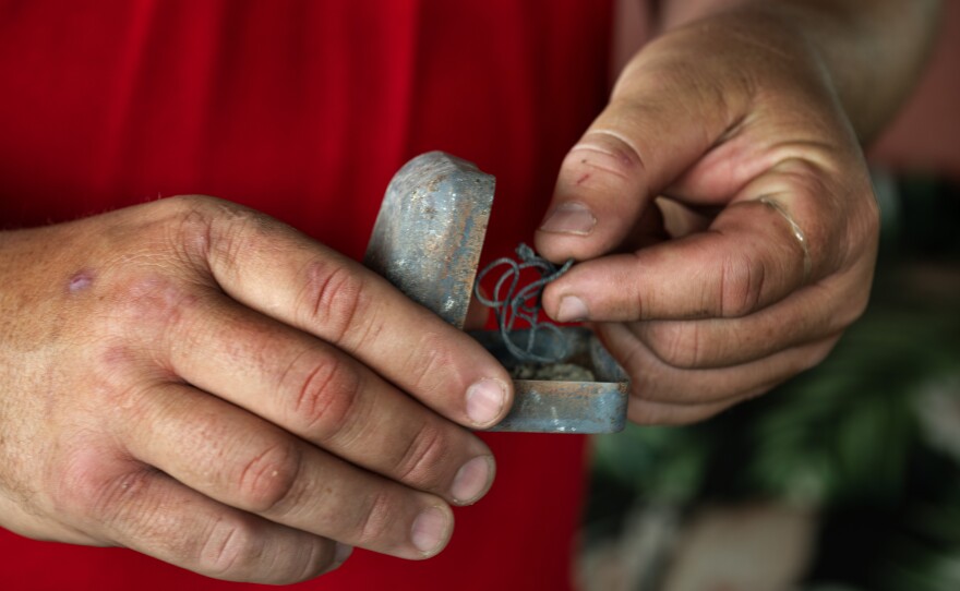 Matthew Souza searched for his wife's wedding rings in the rubble at their burn home after the fire, but found hardly anything intact. He holds a random jewelry box found on site.
