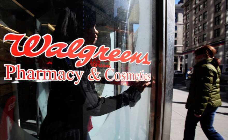 A customer walks out of a Walgreens store in New York City.