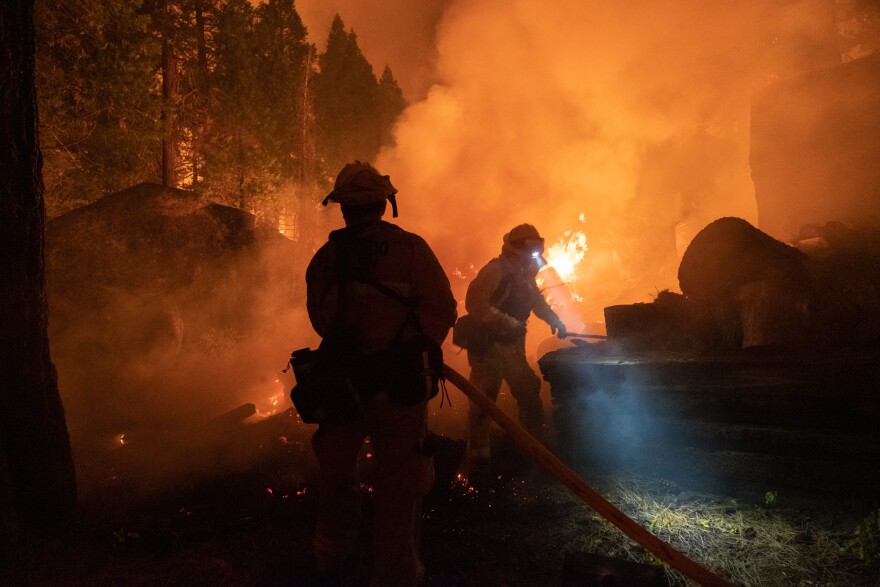 Firefighters protect homes in Christmas Valley from the Caldor Fire. Aug. 30, 2021.  