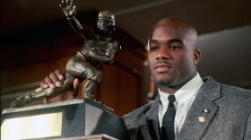 Rashaan Salaam poses with his 1994 Heisman Trophy at the Downtown Athletic Club in New York,  Dec. 10, 1994.