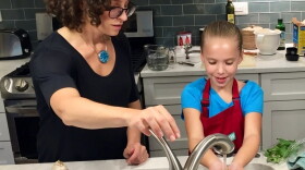 Molly Birnbaum, <em>America's Test Kitchen Kids</em> editor in chief, helps 8-year-old Lucy Gray make a one-pot pasta meal from a recipe in the new book, <em>The Complete Cookbook for Young Chefs</em>.