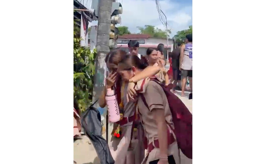 In this photo taken from a video, students react after a shooting incident at the San Jose National High School in Tacloban city, Philippines Monday, June 22, 2026. (James Daantos via AP Photo)