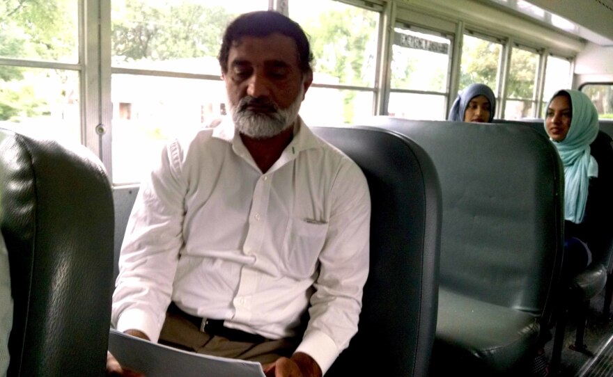 Hafiz Sibtain reviews a sample ballot as he rides a bus to early voting in Nashville.