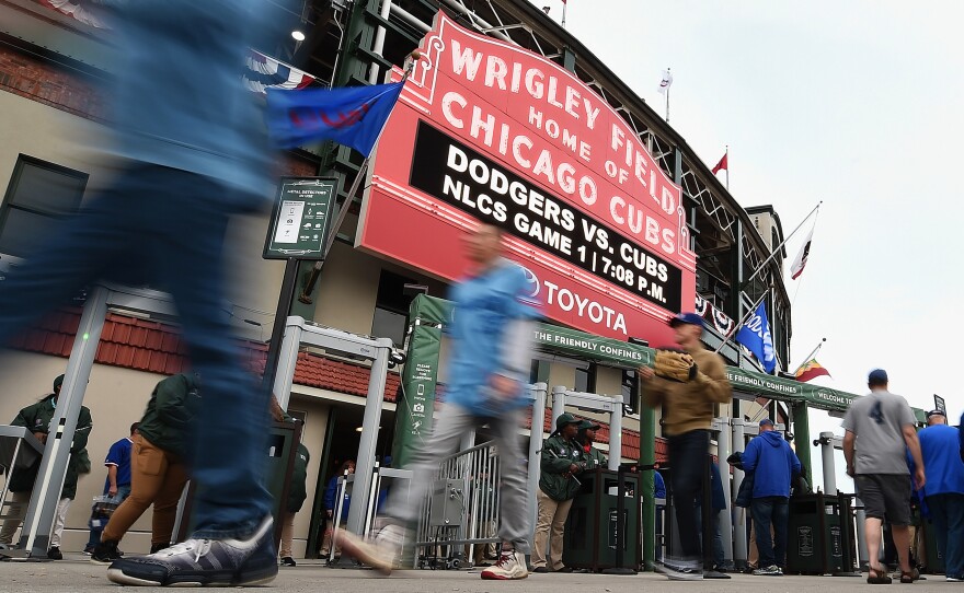 Fans walk outside Chicago's Wrigley Field prior to Game 1 of the National League Championship Series between the Chicago Cubs and the Los Angeles Dodgers on Oct. 15.