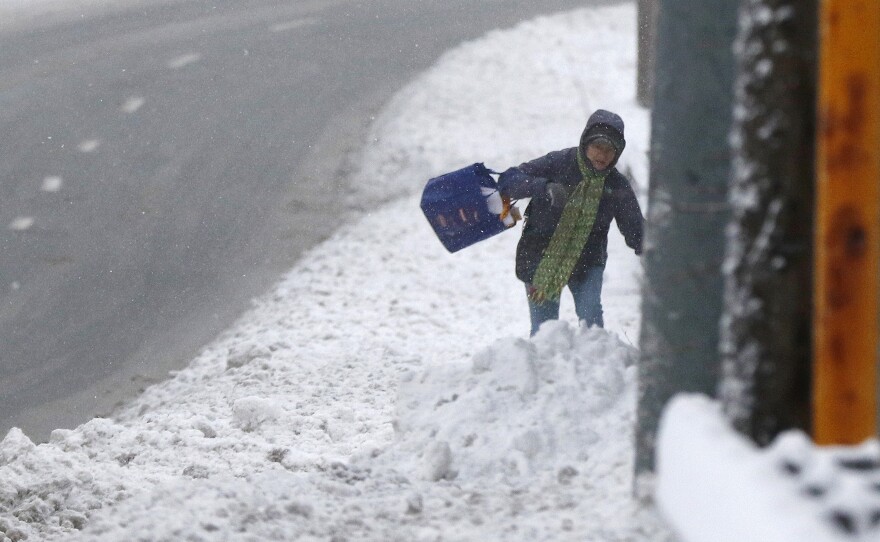 A person stumbles through deep snow Monday in Marlborough, Mass.