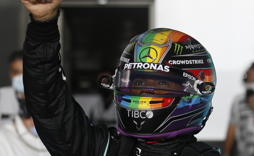 Mercedes driver Lewis Hamilton of Britain reacts after a qualifying session in Losail, Qatar, on Nov. 20, ahead of the Qatar Formula One Grand Prix. Hamilton wore a helmet with a rainbow in solidarity with LGBTQ+ people.