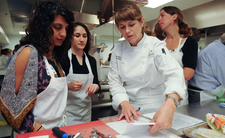 Leah Sarris (center) is the head chef and program director at the Goldring Center for Culinary Medicine at Tulane University. She teaches healthy cooking techniques and educates people about the significant role that food plays in preventing and managing diseases.