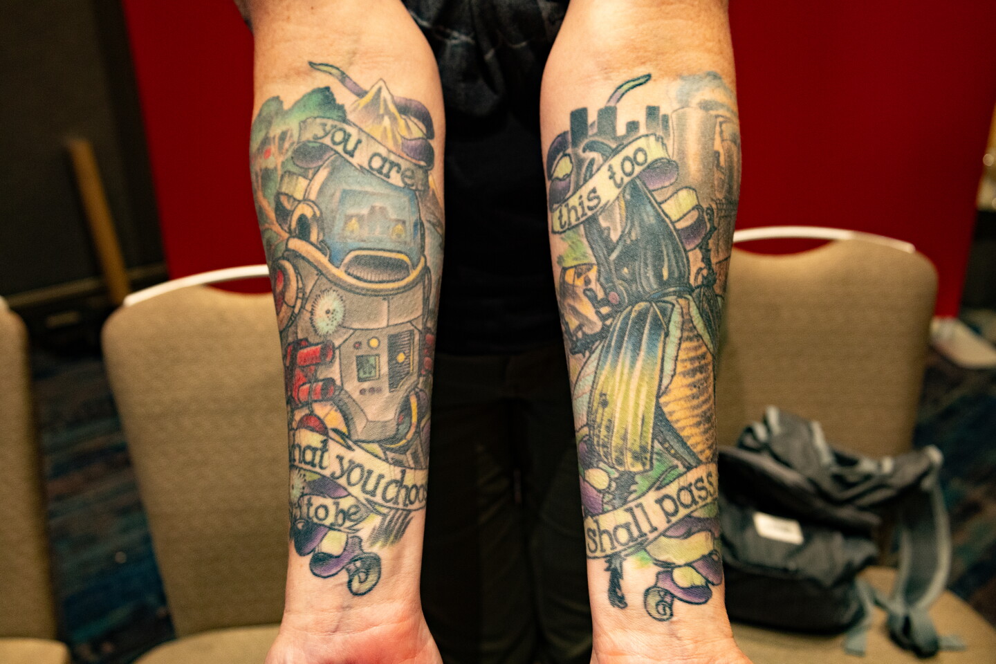Robot and a beetle tattoo sleeves with inspirational quotes decorate an attendee at Comic-Con, July 24, 2026.