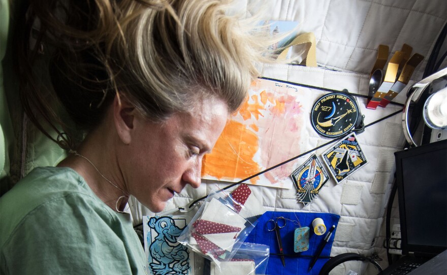 Karen Nyberg sewing on the International Space Station. Featured in CRAFT IN AMERICA "Science"