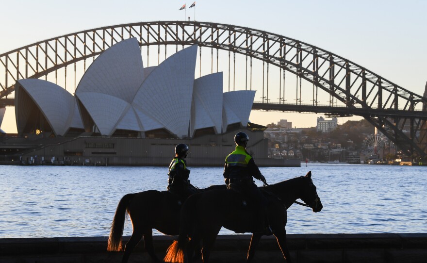 Mounted police officers patrol around the edge of Sydney Harbor on Friday as the city has been locked down amid a new surge in coronavirus infections.