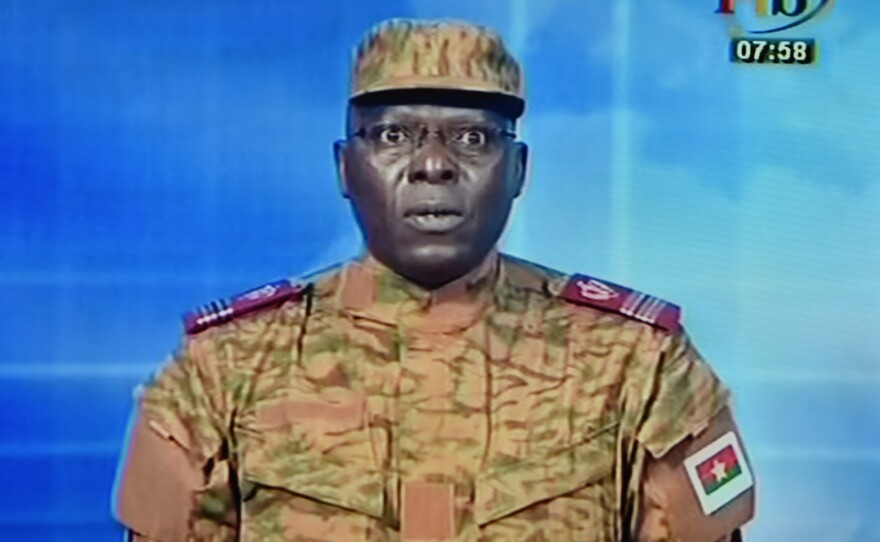 A photo of a TV screen shows the national broadcast in which Lieutenant Colonel Mamadou Bamba announced that the "National Democratic Council" is now in charge of Burkina Faso.