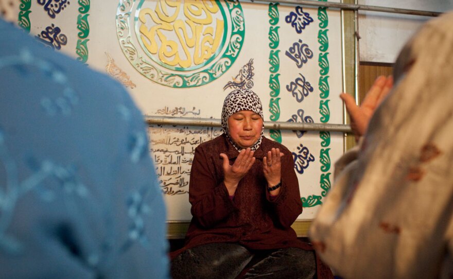 Yao Baoxia, a female imam, sits alongside believers while leading prayers at a mosque for women in Kaifeng in central China. The institution of female imams, known as <em>ahong</em>, is believed to be unique to China.