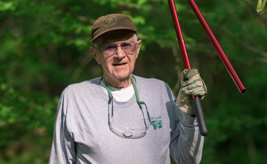 Paul "Doc" Hadala, a volunteer at Great Smoky Mountains National Park, works to eliminate invasive plant species from a section of forest.