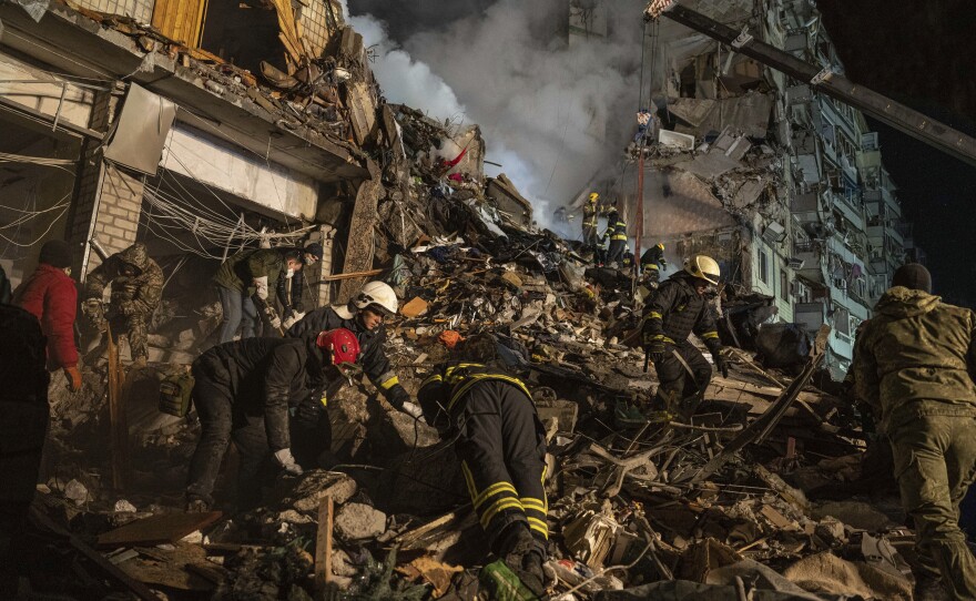 In Dnipro, workers used a crane as they tried to rescue people trapped on upper floors of the apartment tower where about 1,700 were living.