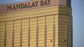 Drapes billow out of broken windows at the Mandalay Bay resort and casino Monday, Oct. 2, 2017, on the Las Vegas Strip following a deadly shooting at a music festival in Las Vegas.