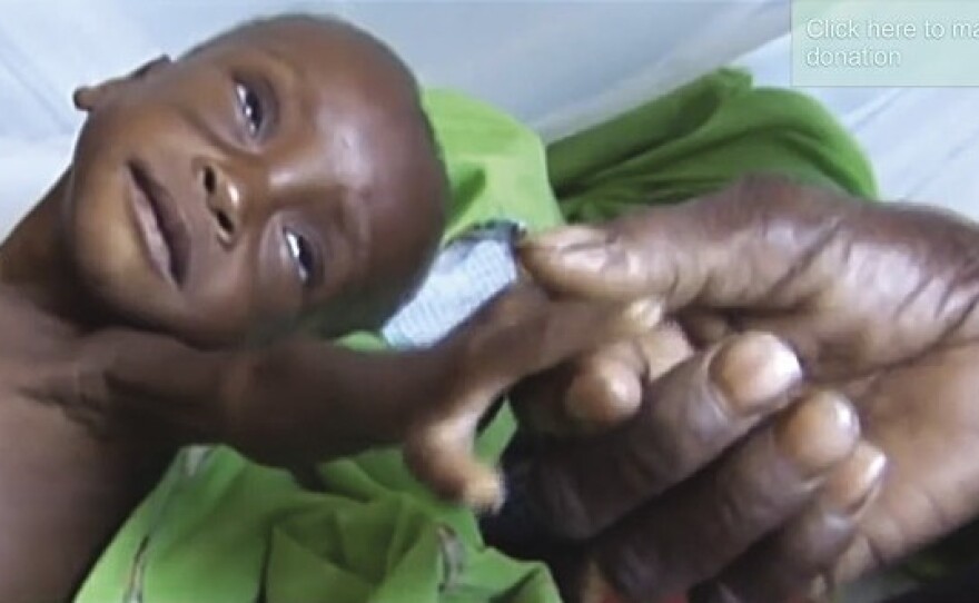 A video still from a Save the Children television fundraising advertisement.