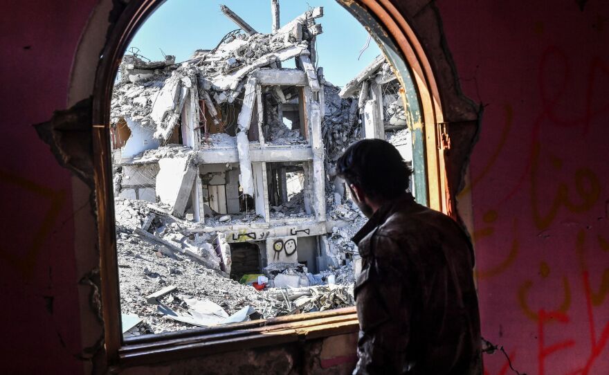 A member of the Syrian Democratic Forces, the rebel group backed by the U.S.-led coalition, looks out upon the ruins of Raqqa last October, toward the end of the coalition's campaign to dislodge the Islamic State from its former stronghold.