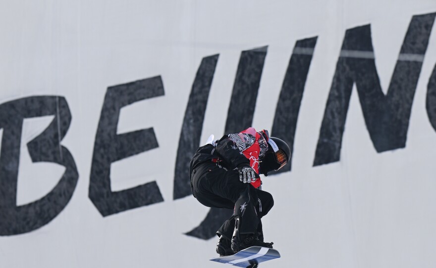 Shaun White performs a trick during the men's snowboard halfpipe qualification.