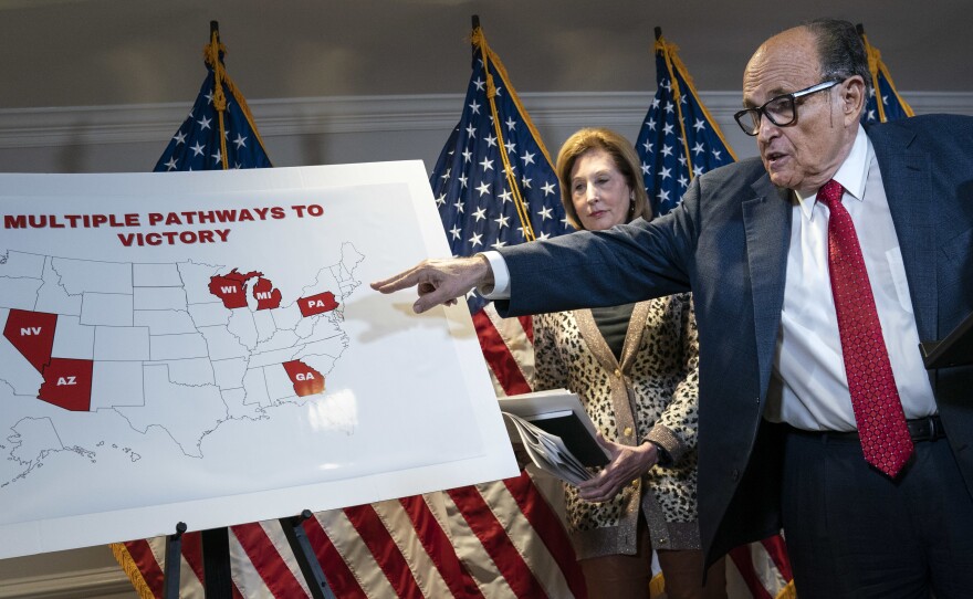President Trump's lawyer Rudy Giuliani points to a map Thursday while speaking to the press about lawsuits related to the 2020 election at the Republican National Committee headquarters in Washington, D.C.