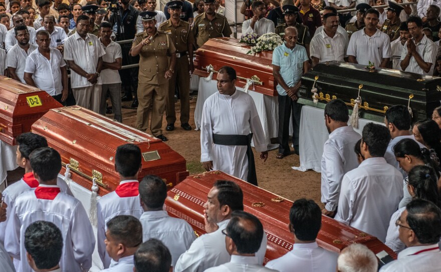 Mourners gather during a mass funeral at St. Sebastian's Church in Negombo on Tuesday, following a series of coordinated bombings of churches and hotels in Sri Lanka on Easter Sunday.