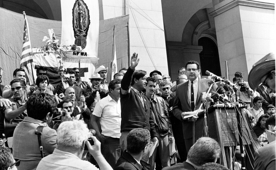 Chavez, leader of the Delano grape pickers' strike, waves to the crowd from the steps of the California Capitol in Sacramento, on April 11, 1966. Chavez led his strikers and followers on a more than 300-mile, 25-day pilgrimage from Delano to Sacramento in an attempt to meet with Gov. Pat Brown on Easter Sunday.