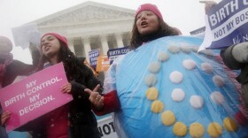  In this March 25, 2015, file photo, Margot Riphagen, of New Orleans, wears a birth control pills costume as she protests in front of the Supreme Court in Washington.