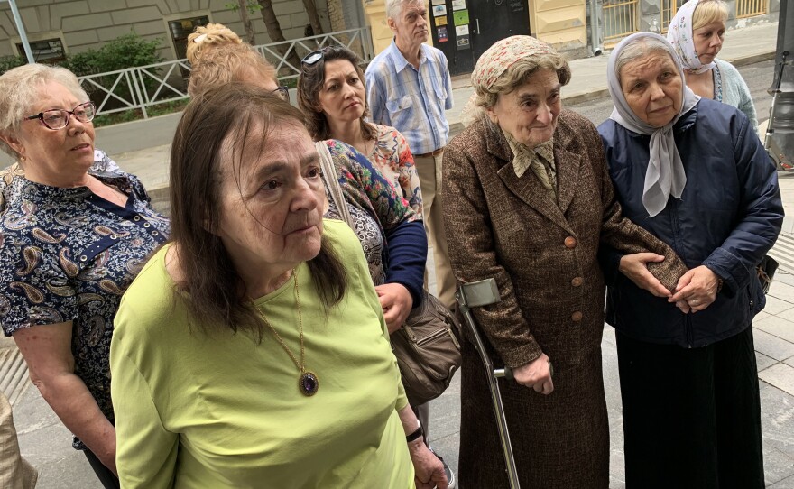 Ksenia Polunina (3rd right, wearing brown coat) visits her childhood apartment building in Moscow as a plaque memorializing her father is hung there. Her father Sergei Polunin was a scientist who was taken away from this building on a February night in 1938 — and then shot by Josef Stalin's secret police.