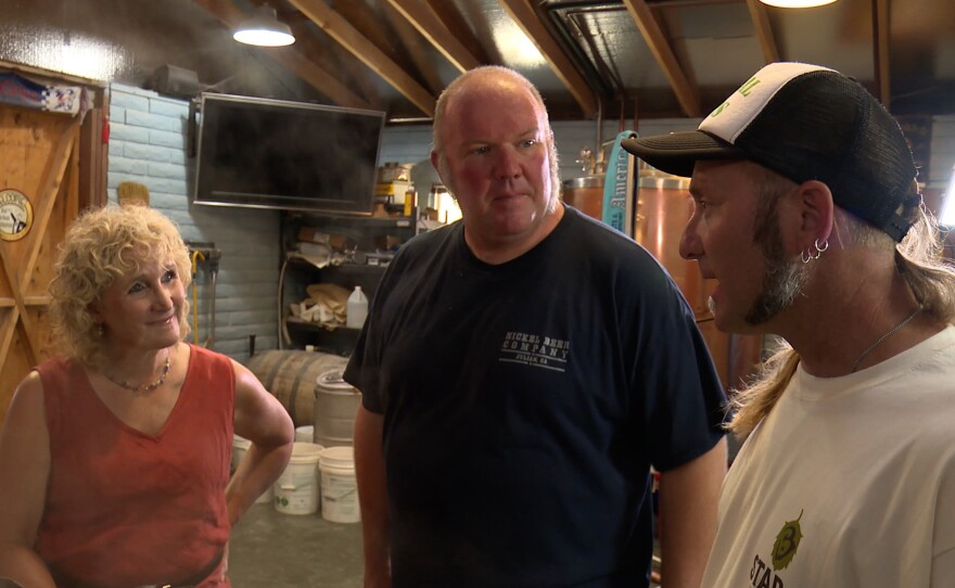 Host Nan Sterman with the brewer and the grower.