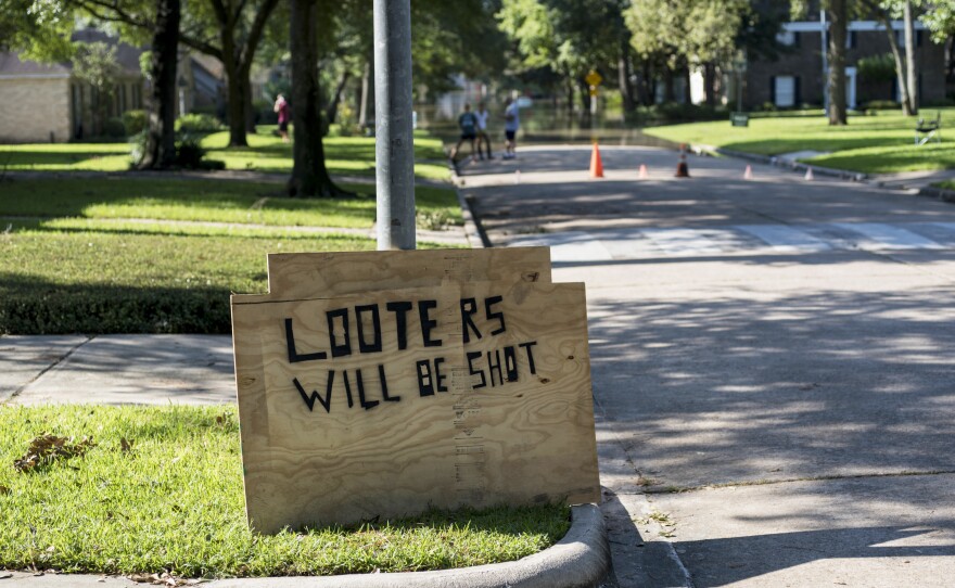 A sign warns against looting in the Nottingham Forrest subdivision. Local and state officials have vowed to crack down on anyone who victimizes the flood victims.