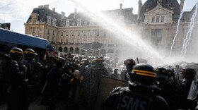 Riot police use a water cannon as they face students during a protest against under-resourced schools, in Rennes, western France, Tuesday.