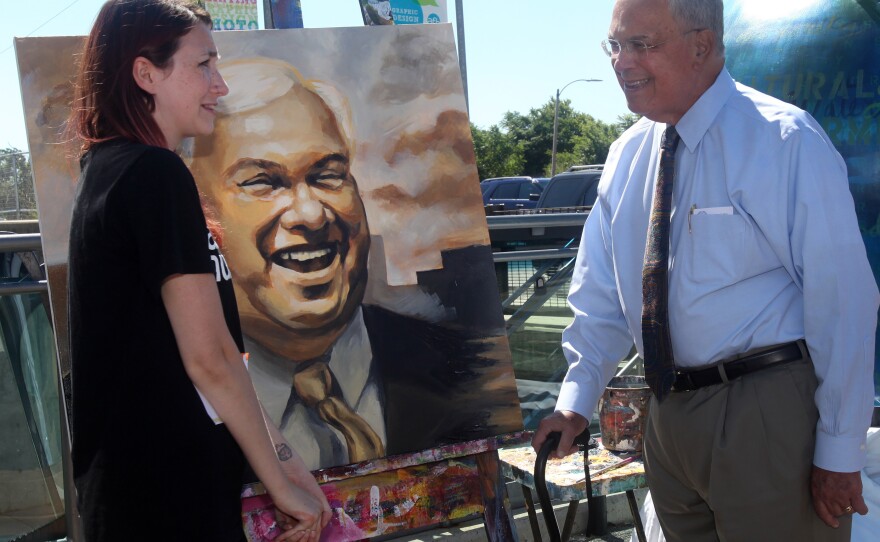 Sadia Bies and Boston Mayor Thomas Menino stand next to her portrait of him at a July press conference. Menino, the city's longest-serving mayor, is stepping down at the end of his term.