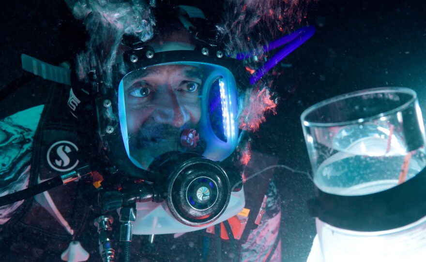 M. Sanjayan examines coral spawn caught in a net in the Maldives.