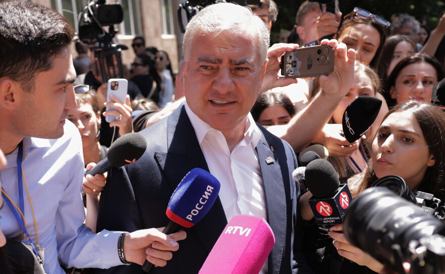 Russian-Armenian tycoon Samvel Karapetyan speaks to the media after voting at a polling station during a parliamentary election in Yerevan, Armenia, Sunday, June 7, 2026.