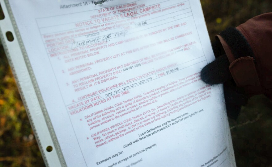 Up the hill from where Norm Ciha camps, Caltrans posts advisories about scheduled cleanups. An ongoing lawsuit claims the agency systematically seizes and destroys people's belongings, violating a constitutional right.