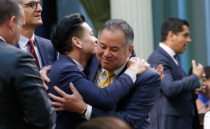 Assemblyman Phil Ting, D-San Francisco, right, chairman of the Assembly Budget Committee is congratulated by fellow Bay Area Democrat, Assemblyman Evan Low, left, after the Assembly approved the state budget in Sacramento, Calif., Thursday, June 13, 2019. Both houses of the Legislature approved the $214.8 billion state budget that spends more on health care and education, bolsters the state's top firefighting agency and boost state reserves.