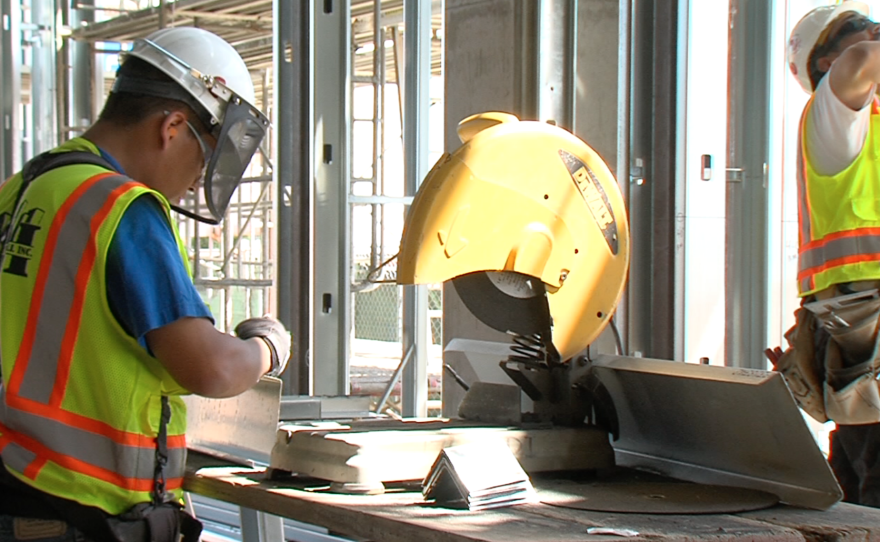 Construction workers put together the commercial space for South Campus Plaza on Aug. 21, 2015.