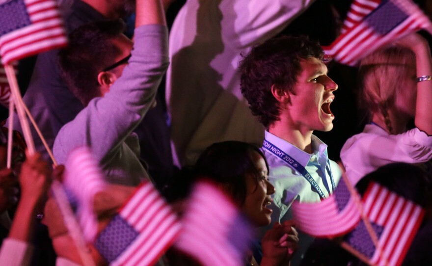 Young supporters cheer as they wait for President Obama at his election night party in 2012 in Chicago.