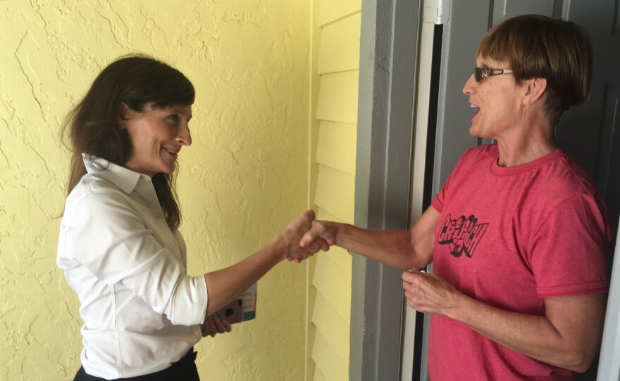 Margaret Good (left), Democratic candidate for a state House seat in Florida, campaigns for votes in Sarasota, Fla., on Monday. Good beat Republican James Buchanan by 7 percentage points in a district that President Trump won two years ago by a 5-point margin.