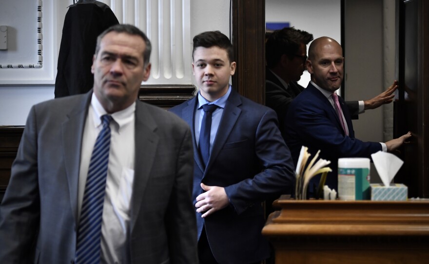 Kyle Rittenhouse, center, enters the courtroom with his attorneys Mark Richards, left, and Corey Chirafisi.