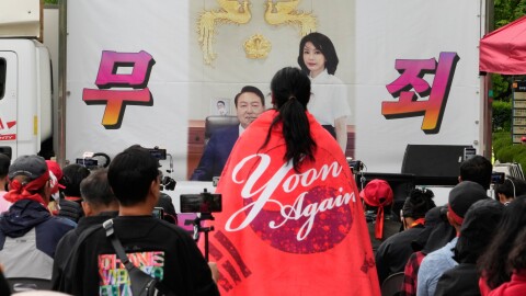 An image of former South Korean President Yoon Suk Yeol and his wife Kim Keon Hee is seen during a rally by supporters outside of the Seoul High Court in Seoul, South Korea, Tuesday, April 28, 2026. The letters read "Not Guilty."