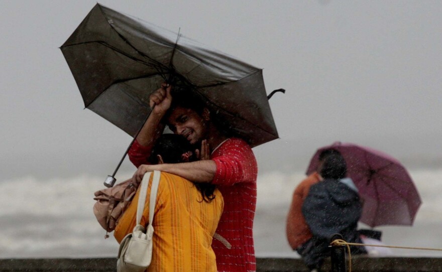 A couple walks in the rain in Mumbai in 2007.