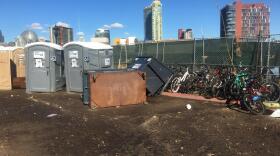 Overturned dumpsters and portable restrooms outside the Alpha Project downtown tent shelter following flooding from a winter storm, Dec. 7, 2018. 