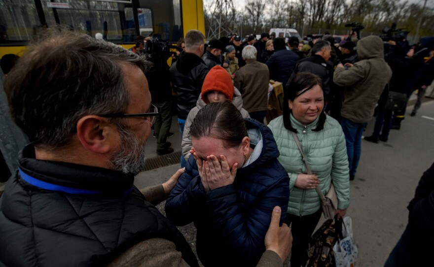 People fleeing the Ukrainian city of Mariupol arrive at a registration center for internally displaced people in Zaporizhzhia on Thursday. They traveled in a small convoy that crossed through territory held by Russian forces, after the opening of a humanitarian corridor.