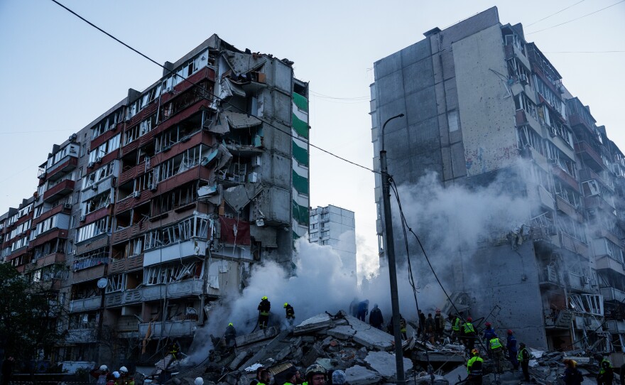 Rescue workers clear the rubble of a house heavily damaged after a Russian strike on a residential neighborhood in Kyiv, Ukraine, on Thursday, May 14, 2026.