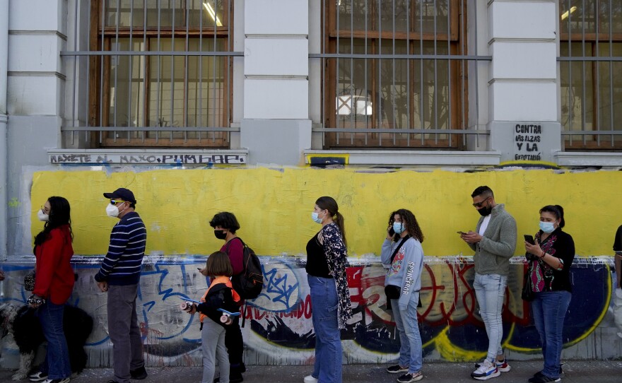 People line up to vote in a plebiscite on a new draft of the Constitution in Santiago, Chile, Sunday, Sept. 4, 2022.